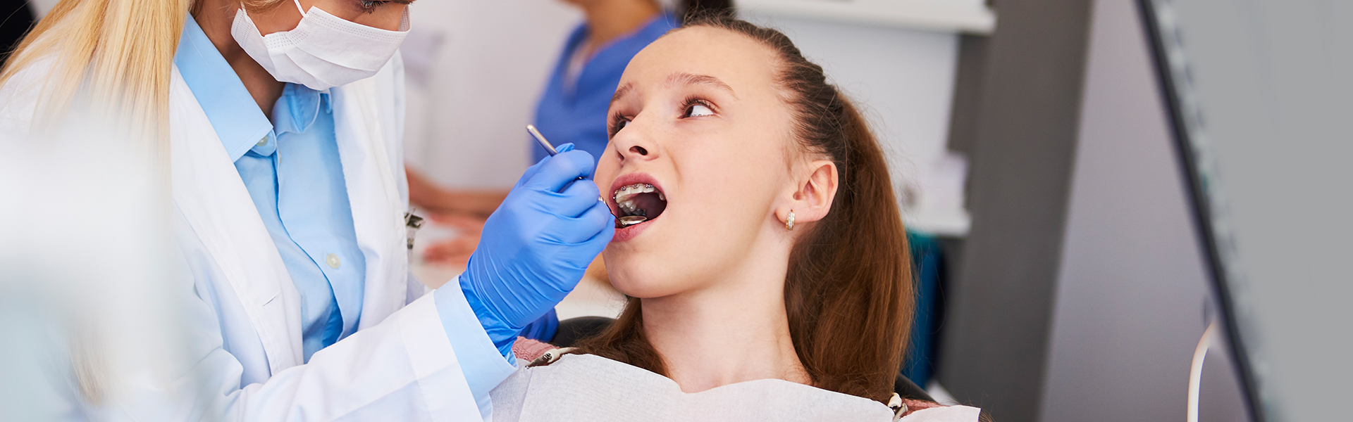 Girl getting oral cancer tests at dental clinic in Brampton.